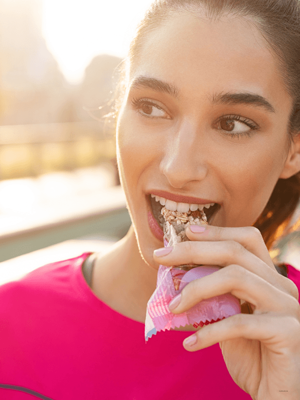 Woman eating a protein bar